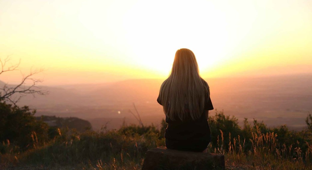 woman looking at sunset