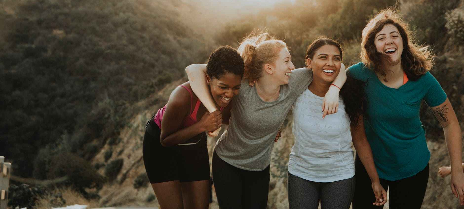 four women standing on mountain