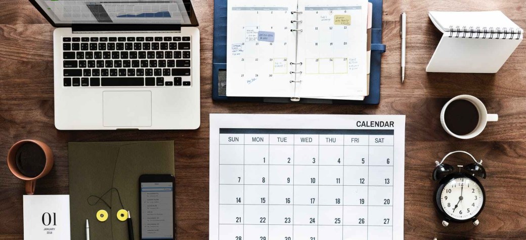 laptop calendar and books